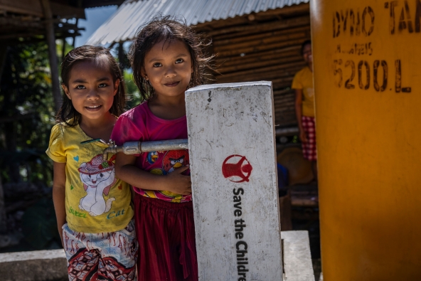 Putri and Jeven by a water tap in West Sumba, Indonesia