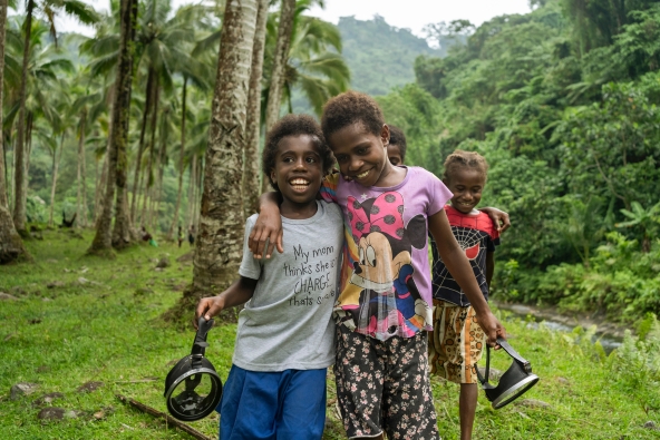 Sylvie, 8, and her friend Florence, 9, walk to the river to catch prawns in Sanma Province, Vanuatu 